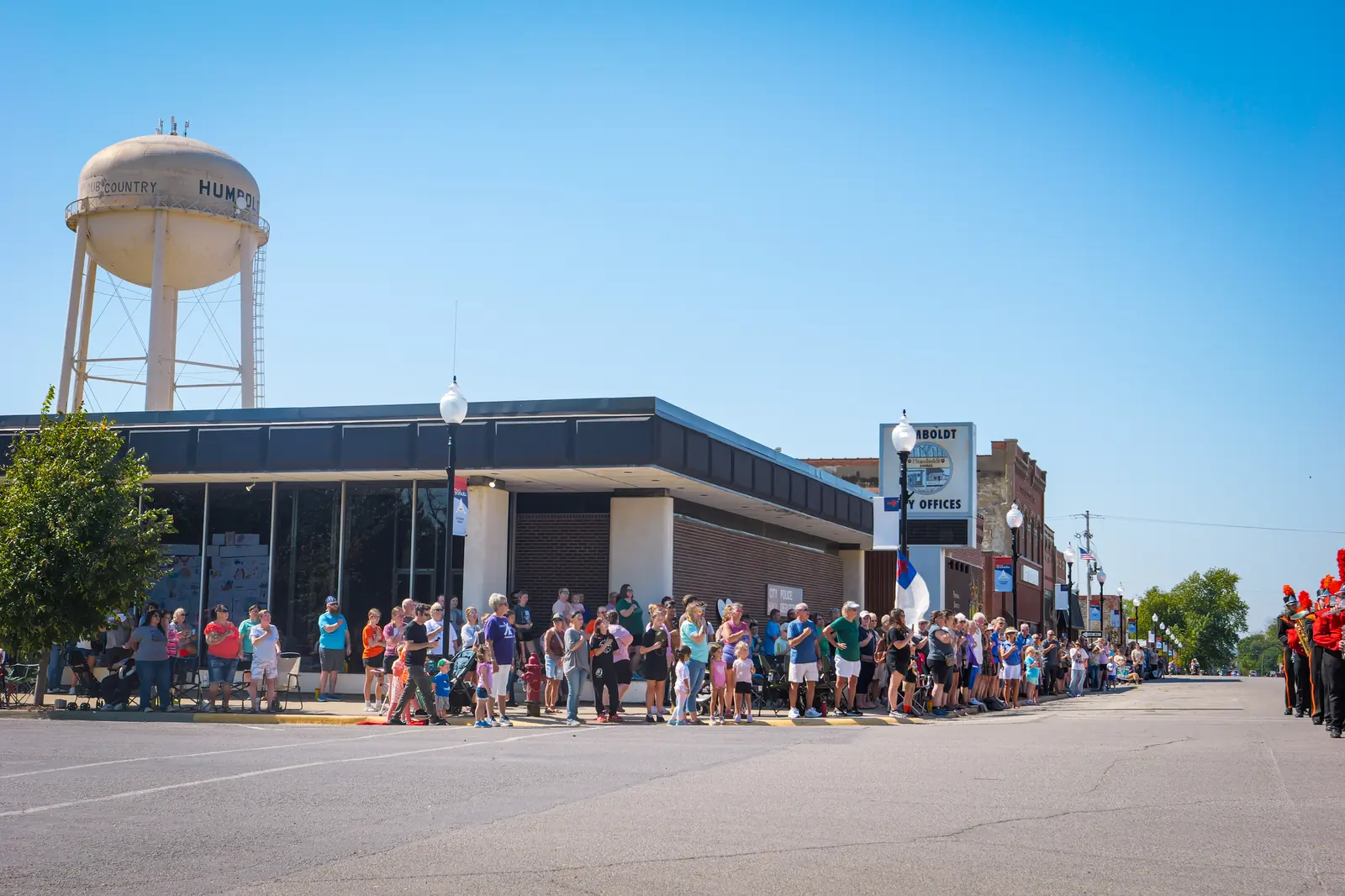 Crowds line the downtown street beneath Humboldt's water tower, waiting for the parade.