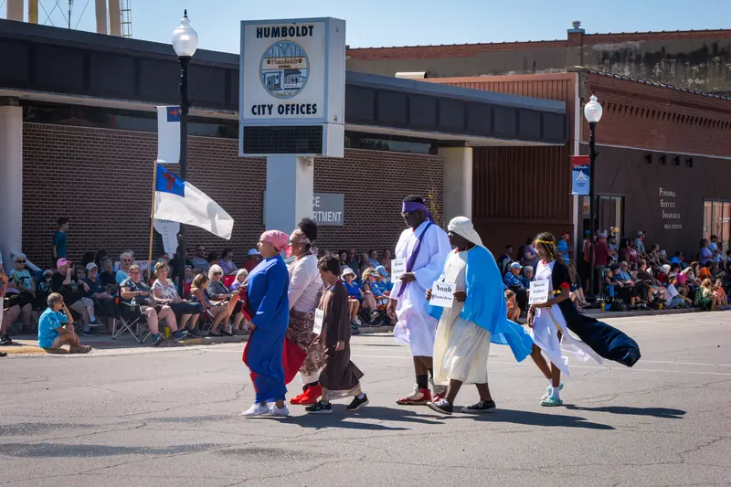 Walkers in biblical costume process past the Humboldt City Offices sign.